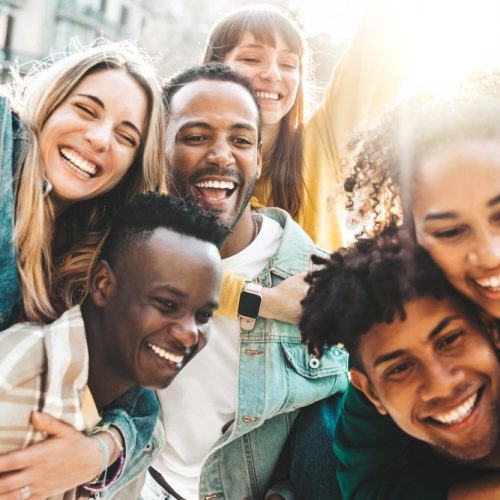 Happy,Multiracial,Friends,Having,Fun,Hanging,Out,On,City,Street